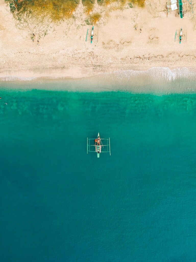 islands with a boat- photos by https://www.pexels.com/@jaysantiago11/